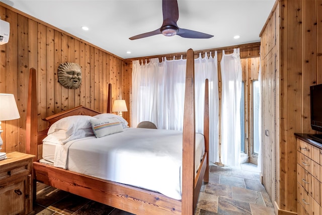 362 Ocean Walk, Fire Island Pines, NY 11782 - bedroom featuring stone finish floors, wood walls, recessed lighting, a ceiling fan, and an AC wall unit