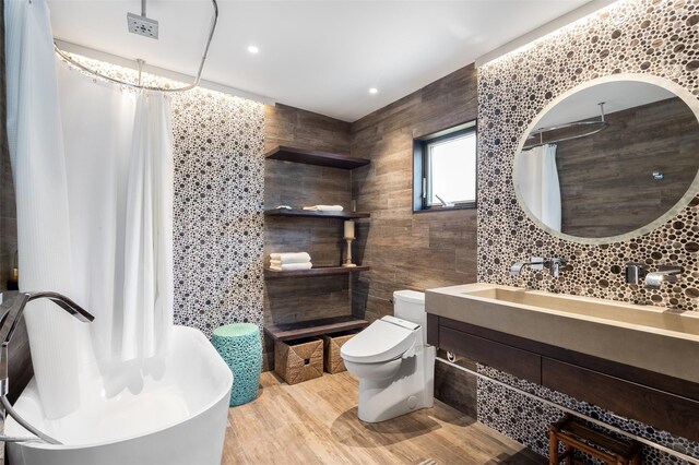 362 Ocean Walk, Fire Island Pines, NY 11782 - bathroom featuring tile walls, toilet, a freestanding bath, vanity, and curtained shower
