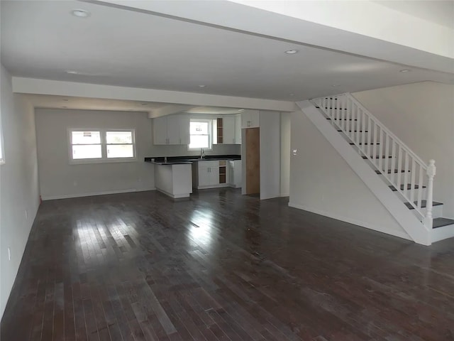 unfurnished living room with dark hardwood / wood-style flooring