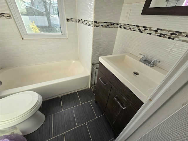 full bathroom with toilet, tub / shower combination, tile walls, tile patterned floors, and vanity