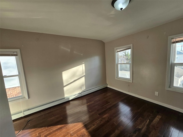 unfurnished room with baseboard heating and dark hardwood / wood-style flooring