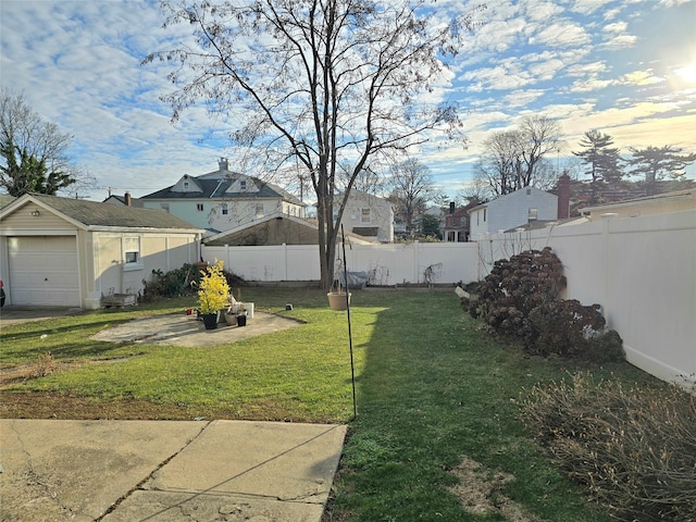 view of yard featuring a patio, a garage, and an outdoor structure