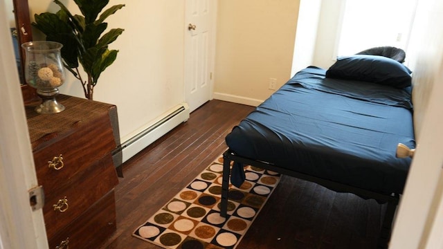 110-17 Monterey St, Queens Village, NY 11429 - bedroom with dark wood-style floors, baseboard heating, and baseboards