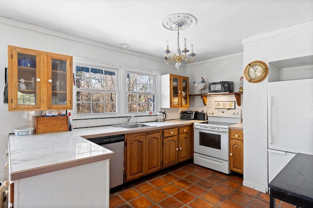 kitchen with kitchen peninsula, white appliances, sink, an inviting chandelier, and hanging light fixtures