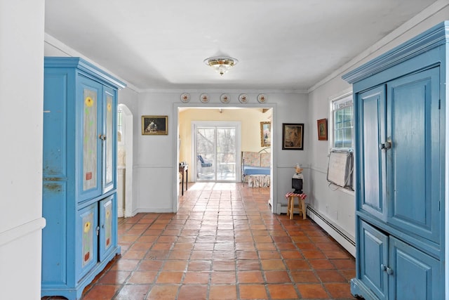 foyer featuring ornamental molding and a baseboard heating unit