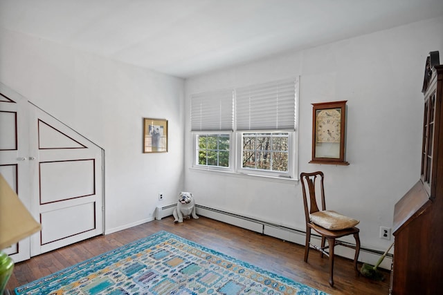 living area featuring dark hardwood / wood-style flooring and baseboard heating