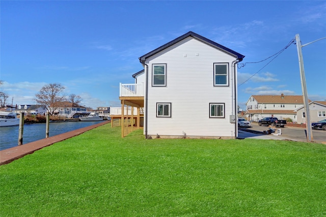 view of side of property with a lawn and a water view