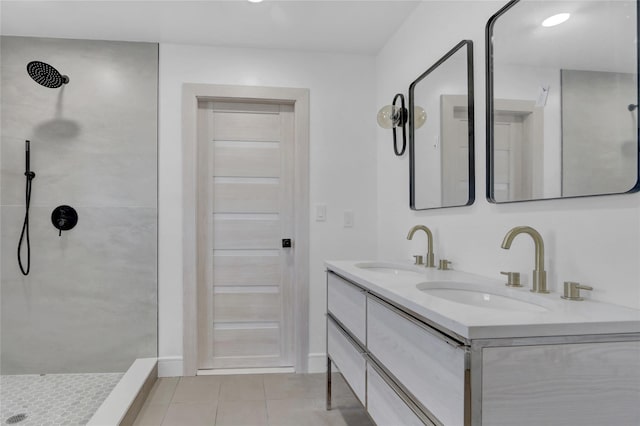 bathroom featuring tile patterned floors, vanity, and tiled shower