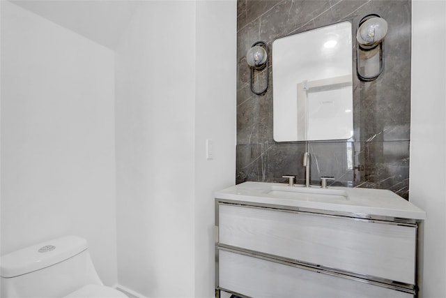 bathroom featuring vanity and toilet