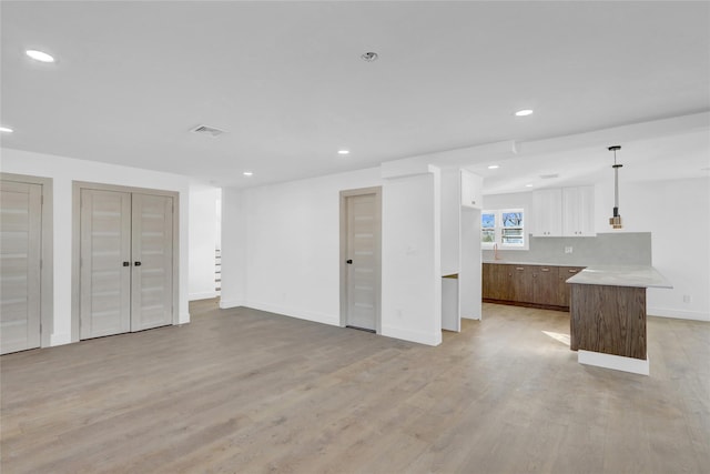 unfurnished living room featuring light wood-type flooring