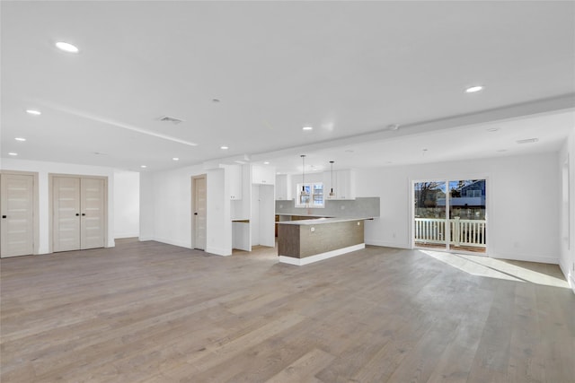 unfurnished living room featuring light hardwood / wood-style floors