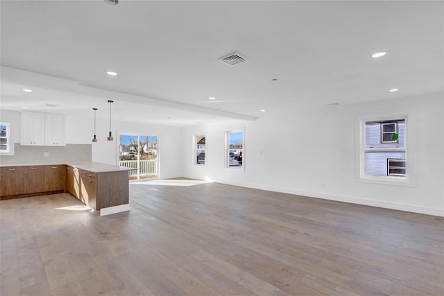 unfurnished living room with light wood-type flooring