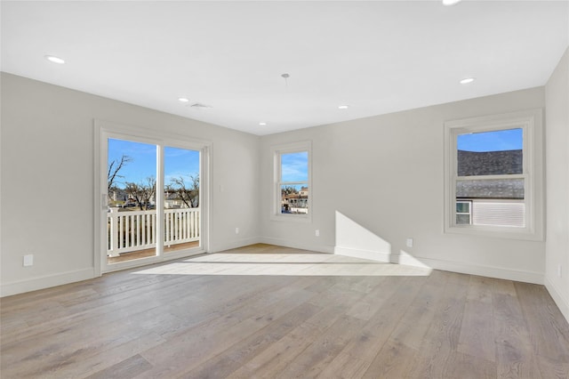 spare room featuring light hardwood / wood-style flooring