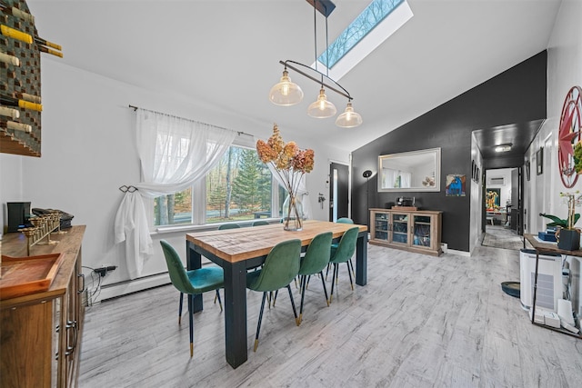 dining area featuring high vaulted ceiling, a skylight, light hardwood / wood-style floors, and a baseboard radiator