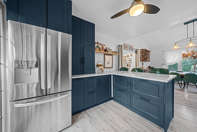 kitchen featuring blue cabinets, kitchen peninsula, stainless steel fridge with ice dispenser, and light hardwood / wood-style flooring