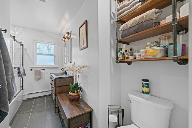 full bathroom featuring sink, baseboard heating, bath / shower combo with glass door, tile patterned floors, and toilet