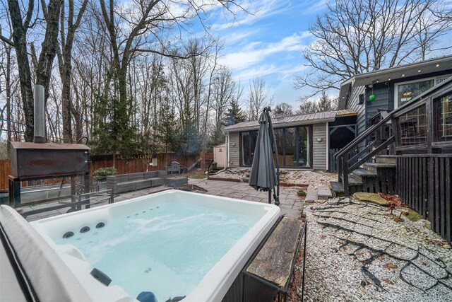 view of swimming pool with a hot tub and a patio