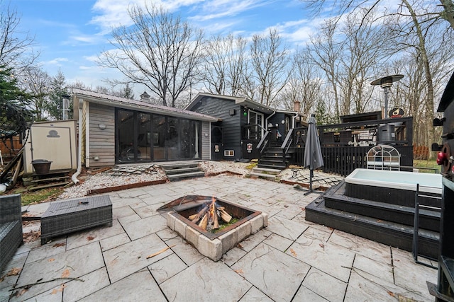 view of patio / terrace featuring a shed and an outdoor fire pit