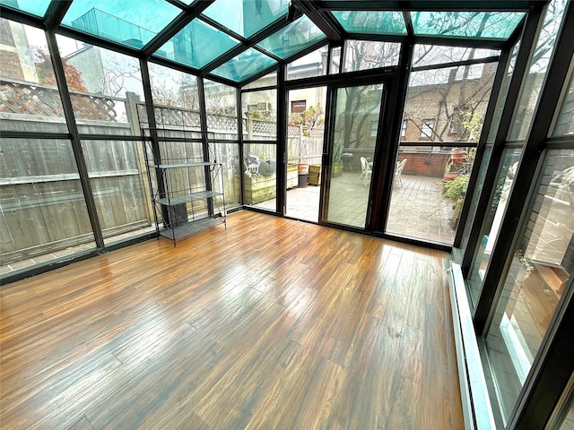 unfurnished sunroom featuring baseboard heating and vaulted ceiling