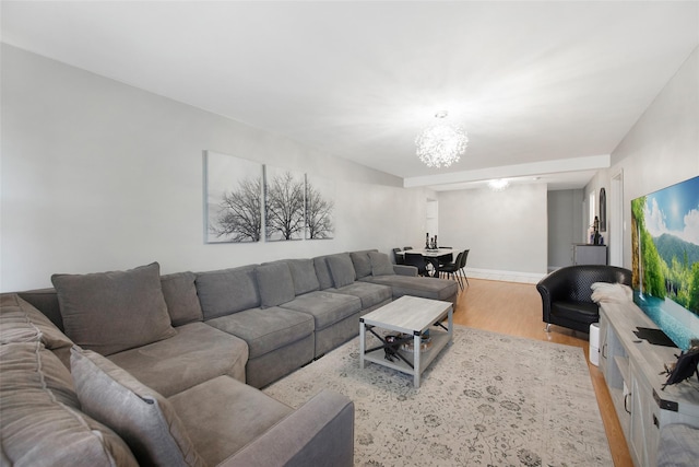 living room featuring light hardwood / wood-style flooring and a chandelier