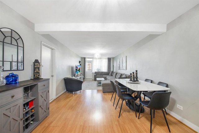 dining room featuring a chandelier and light hardwood / wood-style floors