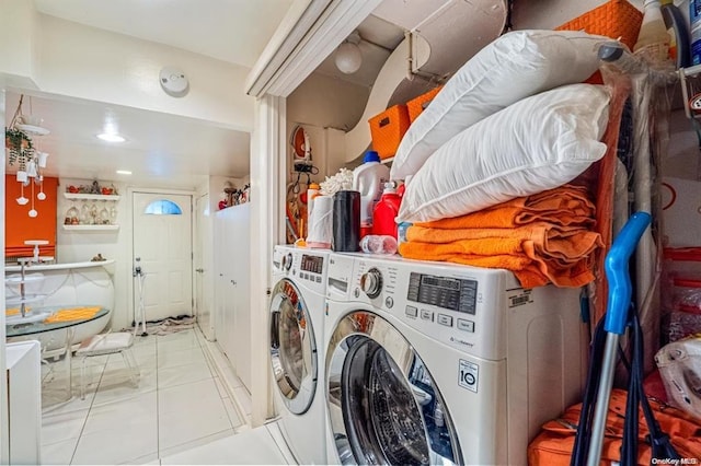 laundry room with washer and dryer and light tile patterned floors