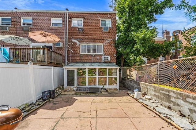 rear view of house with a patio area and a sunroom