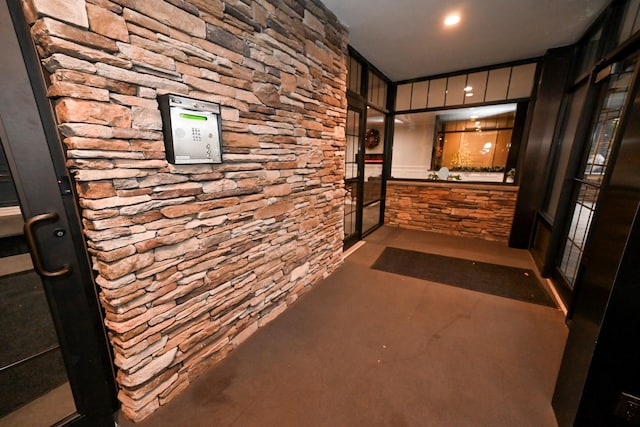 hallway with concrete floors