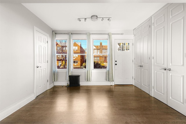 interior space featuring radiator heating unit and dark wood-type flooring