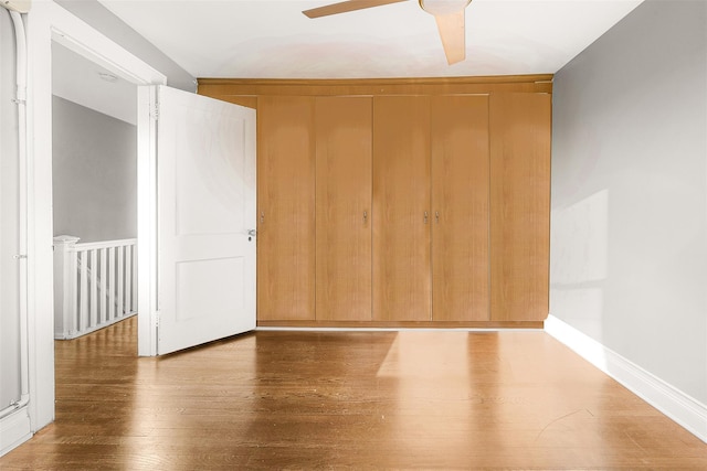 unfurnished bedroom featuring ceiling fan and hardwood / wood-style floors