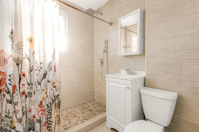 bathroom featuring a wealth of natural light, vanity, and walk in shower