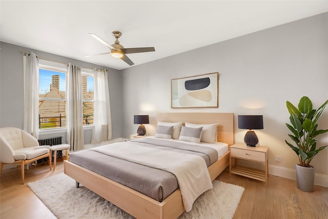 bedroom featuring light wood-type flooring and ceiling fan