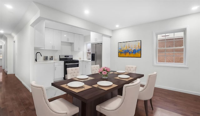 dining area featuring dark hardwood / wood-style flooring and sink