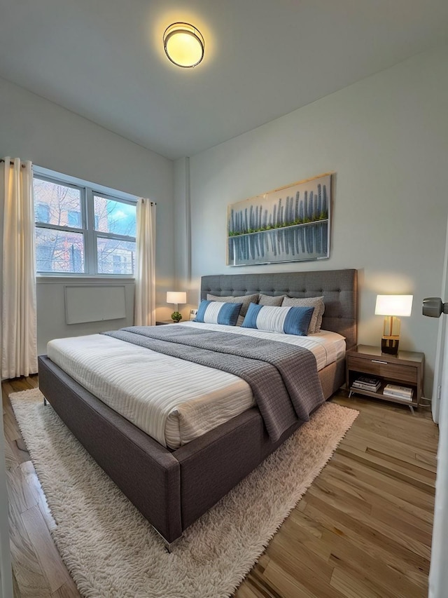 bedroom with hardwood / wood-style flooring