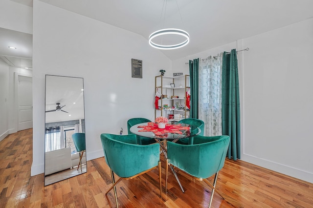 dining space with wood-type flooring and ceiling fan