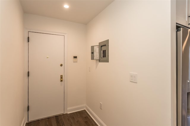 doorway to outside with electric panel and dark hardwood / wood-style flooring