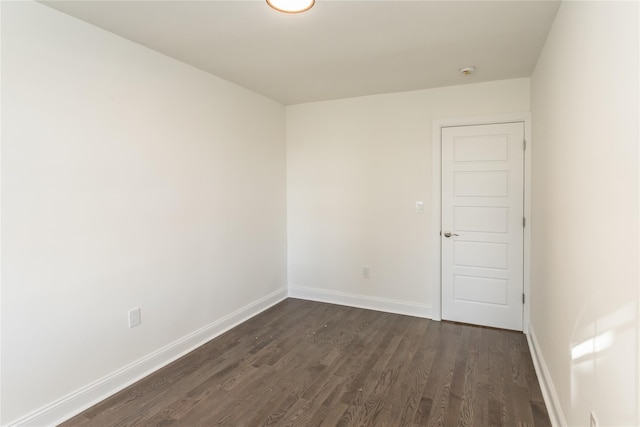 unfurnished room featuring dark hardwood / wood-style flooring