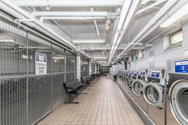 washroom with tile patterned flooring and washing machine and dryer