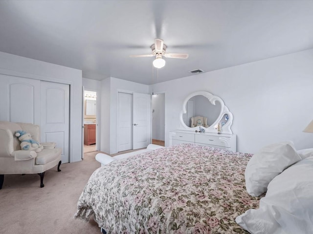 bedroom with light carpet, connected bathroom, and ceiling fan