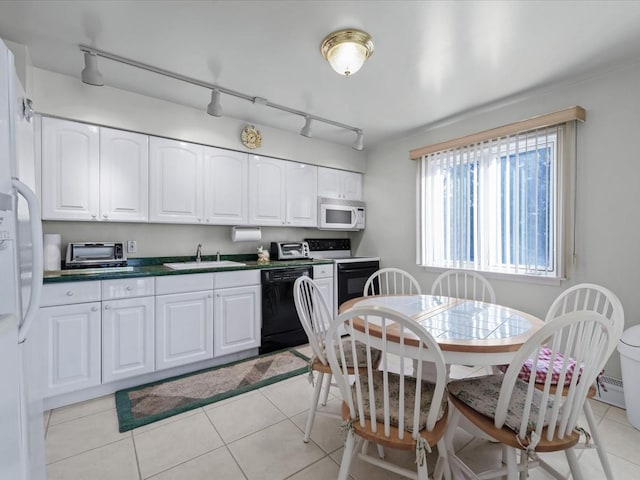 kitchen featuring rail lighting, white appliances, sink, light tile patterned floors, and white cabinetry