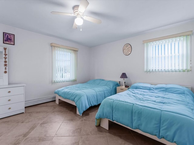 bedroom with ceiling fan, a baseboard heating unit, and light tile patterned flooring