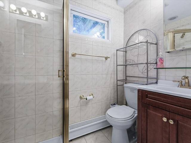 bathroom featuring vanity, toilet, baseboard heating, tile walls, and walk in shower