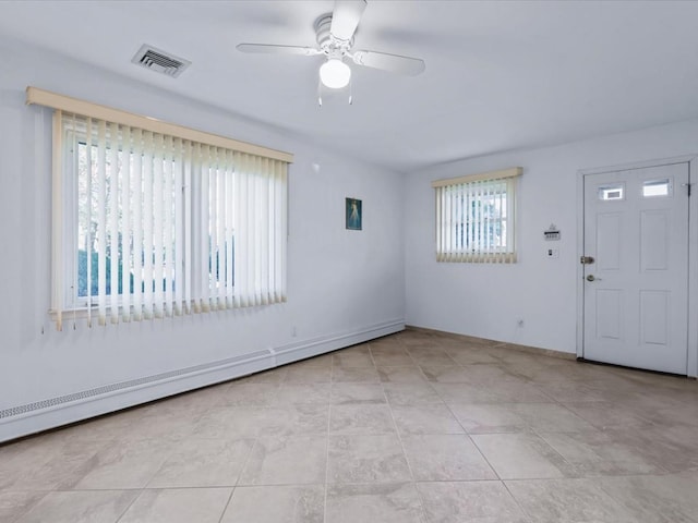 tiled entrance foyer featuring ceiling fan and a baseboard heating unit