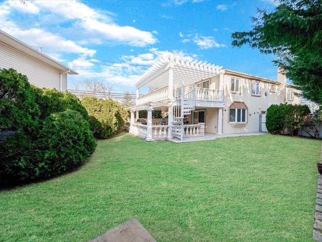 back of house featuring a pergola, a patio area, and a lawn