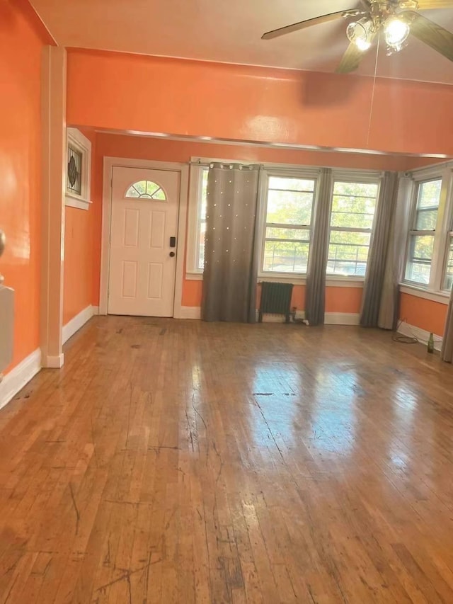 entryway featuring radiator heating unit, ceiling fan, and wood-type flooring