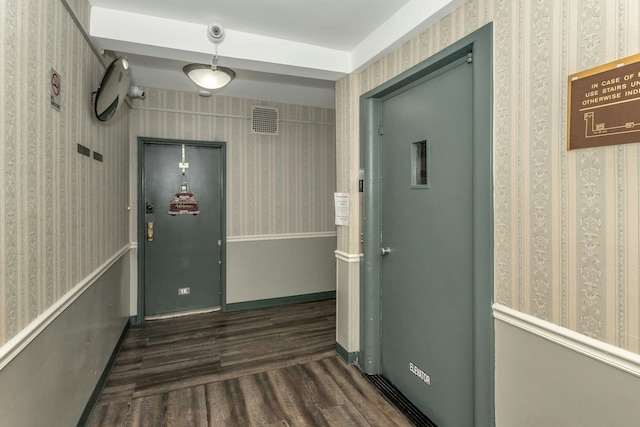 hallway with dark hardwood / wood-style flooring and elevator