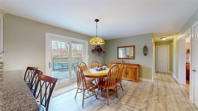 dining space with light wood-type flooring