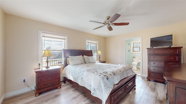 bedroom with light wood-type flooring, ensuite bathroom, and ceiling fan