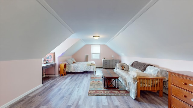 bedroom featuring light wood-type flooring, a baseboard radiator, and lofted ceiling