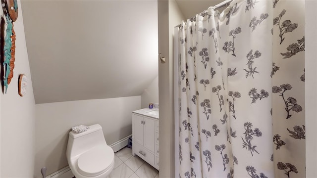 bathroom with vanity, vaulted ceiling, tile patterned flooring, toilet, and baseboard heating